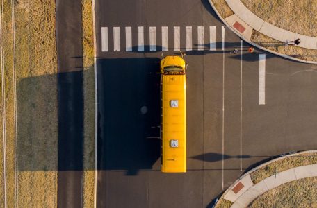 Aerial view of school bus driving on a rural street